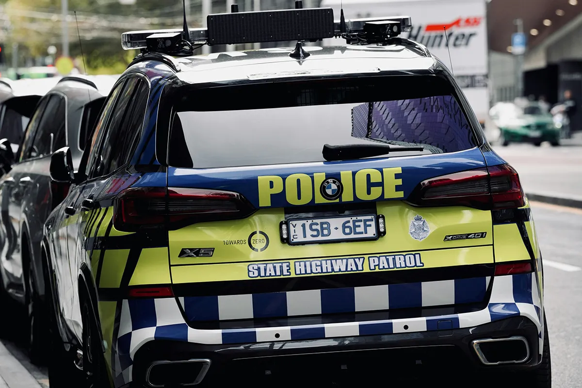 Rear view of a Victoria Police State Highway Patrol BMW X5 parked on a city street