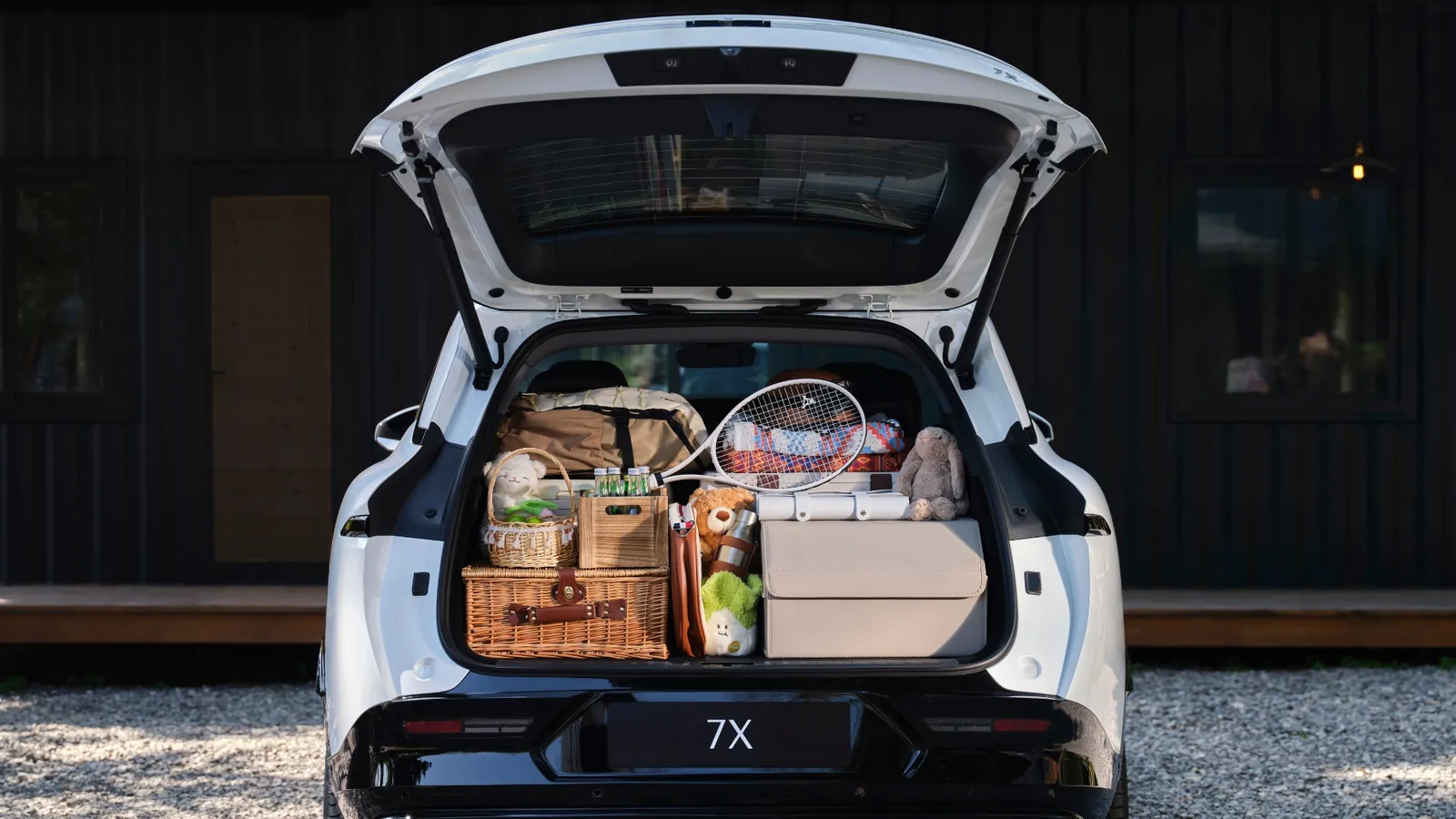 Zeekr 7X tailgate open with the boot loaded with picnic baskets and bags