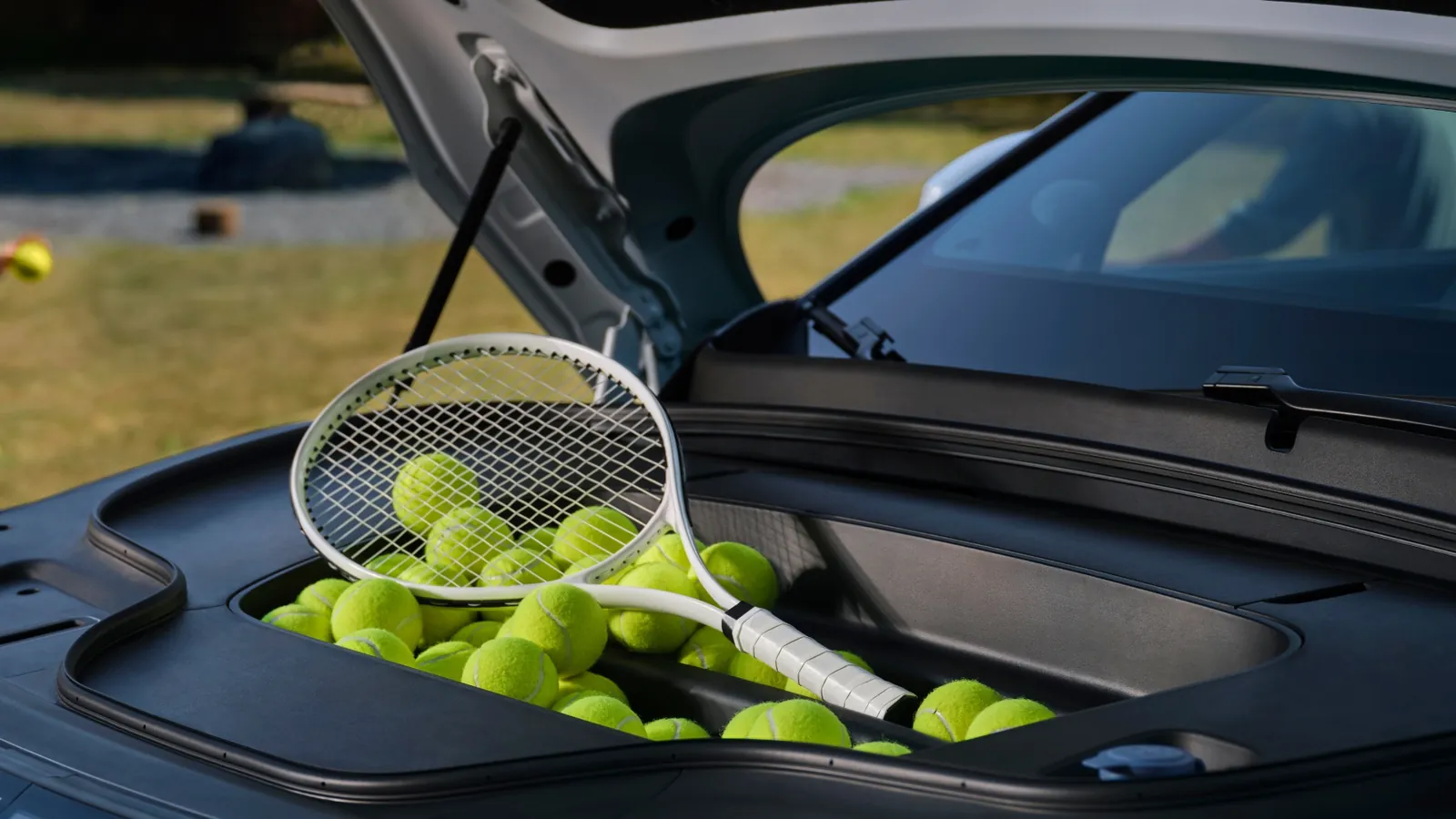 Zeekr 7X front trunk under the bonnet holding a tennis racquet and balls