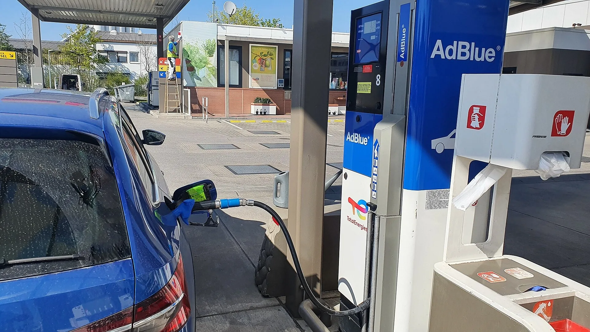 Blue diesel wagon filling up at a dedicated AdBlue pump at a service station in Munich, Germany