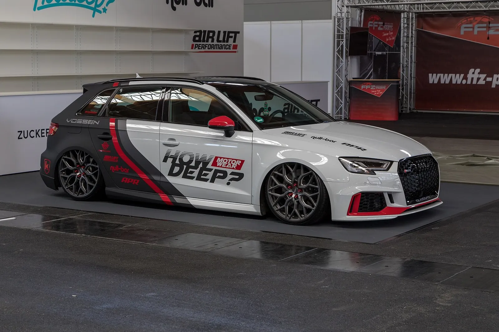 Audi RS3 Sportback show car lowered on adjustable air suspension on a display stand at a tuning show