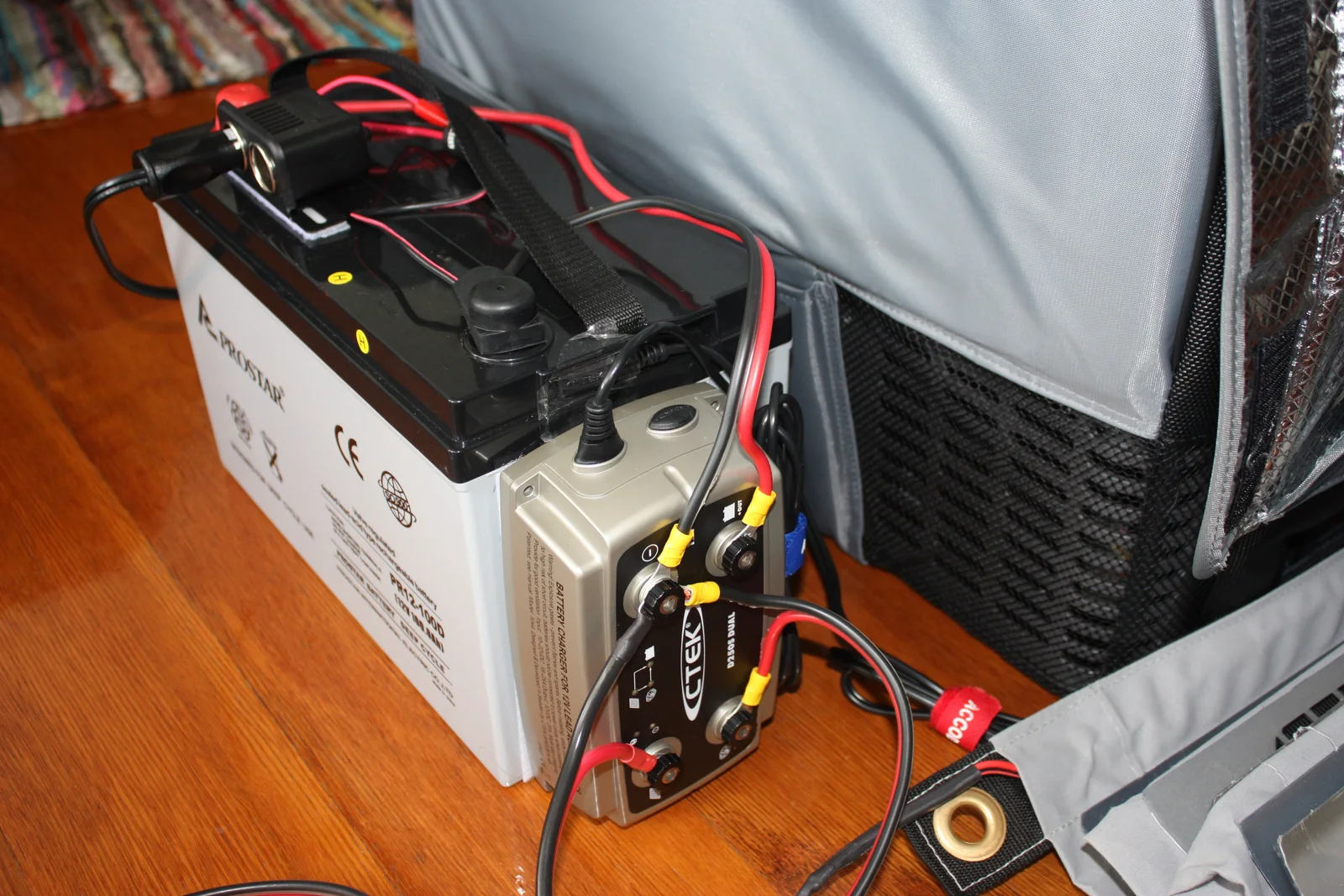 100Ah AGM auxiliary battery wired to a CTEK DC-DC charger beside a 12V fridge in an insulated cover