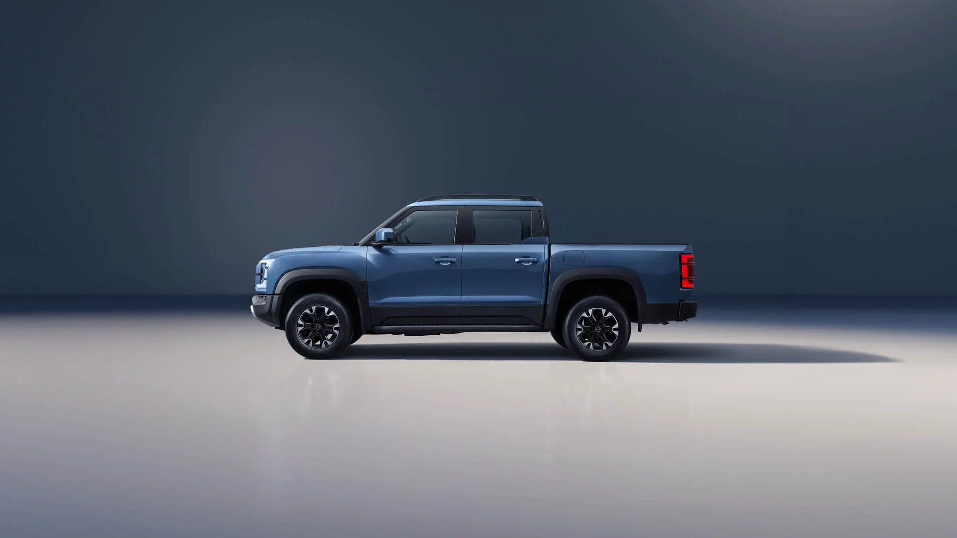 Blue BYD Shark 6 Premium dual-cab pick-up in full side profile against a dark studio backdrop