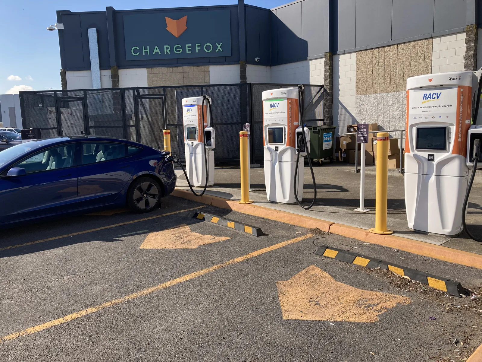 Tesla Model 3 at the Chargefox and RACV fast charging station in Airport West, Melbourne, with chargers in a row