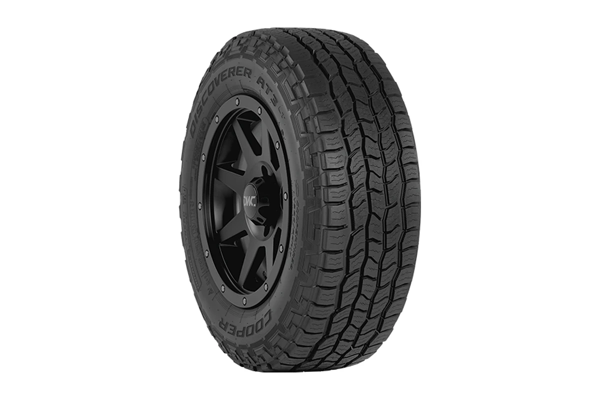 Cooper Discoverer AT3 LT light-truck all-terrain tyre on a black wheel showing the sidewall lettering