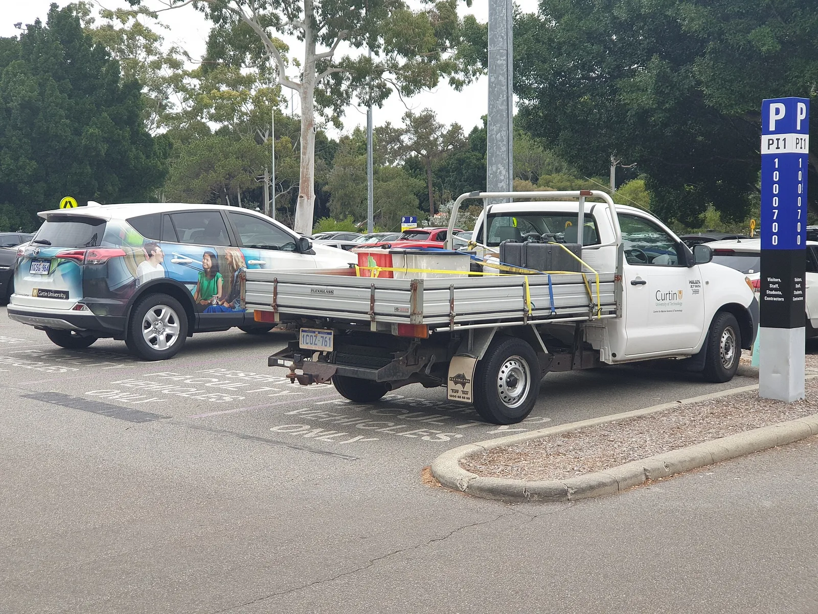 White Toyota HiLux Workmate tray-back fleet ute parked at Curtin University in Perth