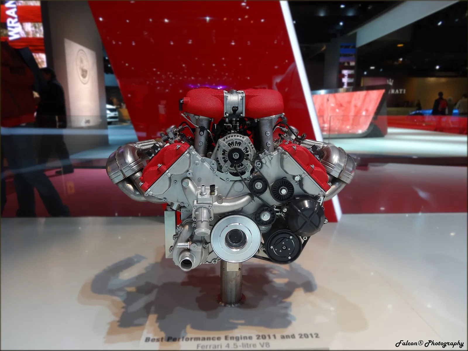 Ferrari 4.5-litre naturally aspirated V8 from the 458 family on a display stand with its 2011 and 2012 engine award placard