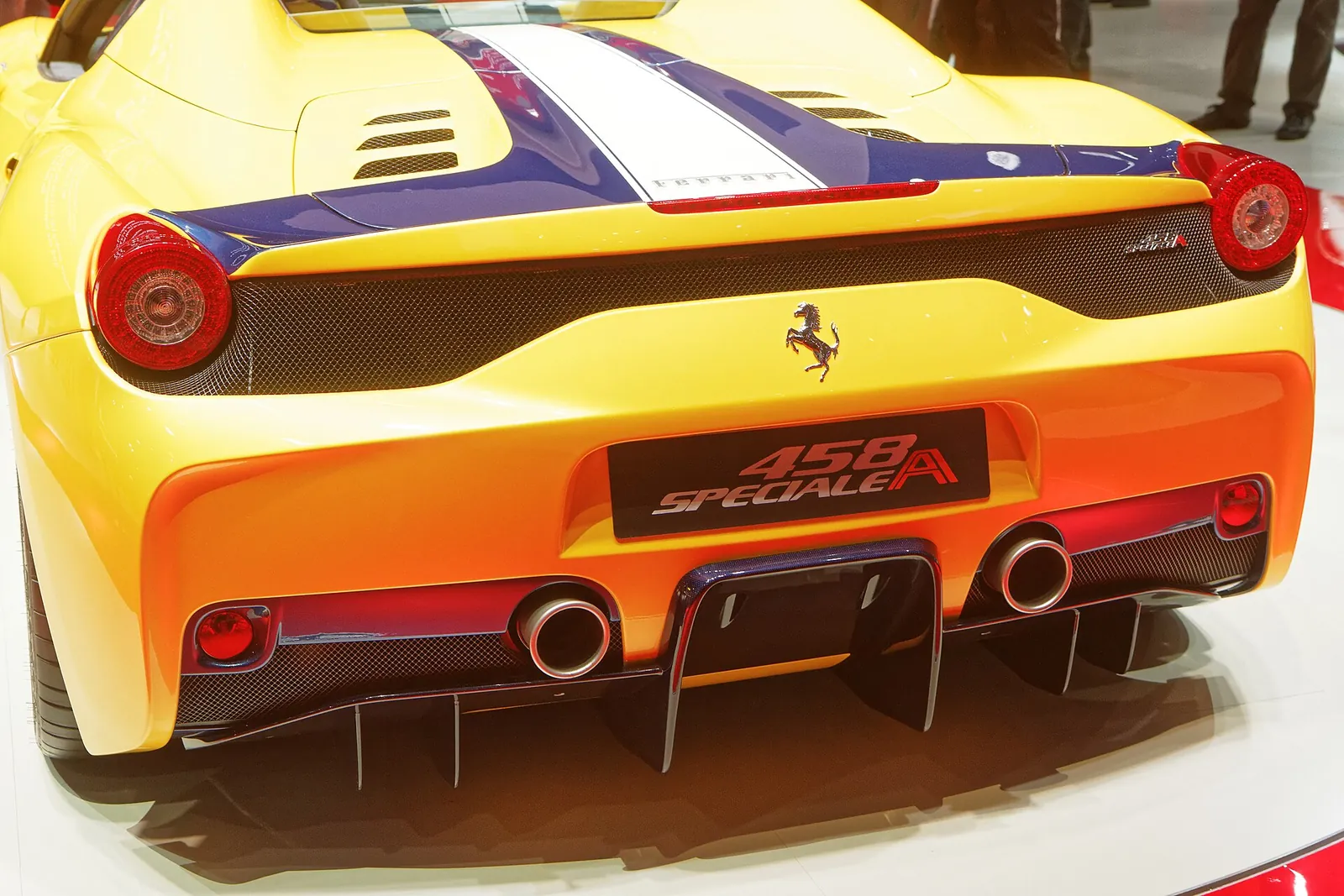 Rear view of a yellow Ferrari 458 Speciale A showing its badge, diffuser and central exhausts
