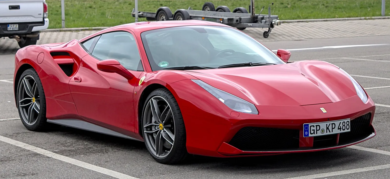 Red Ferrari 488 GTB, the twin-turbo V8 replacement for the 458, front three-quarter view showing its split side intake