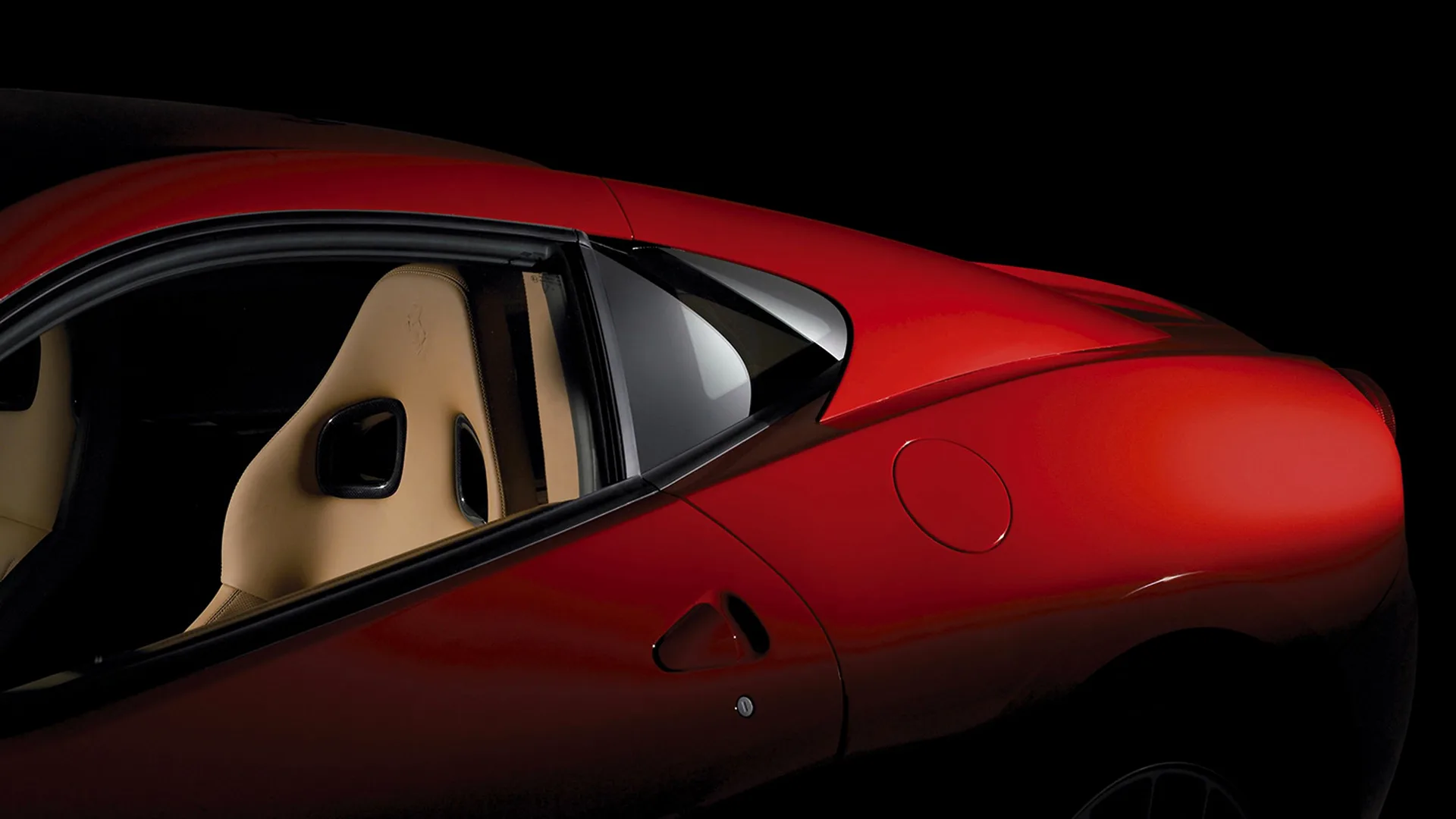 Ferrari 599 GTB Fiorano teaser Red Ferrari 599 GTB Fiorano flank, flying buttress and rear haunch lit against a black studio background