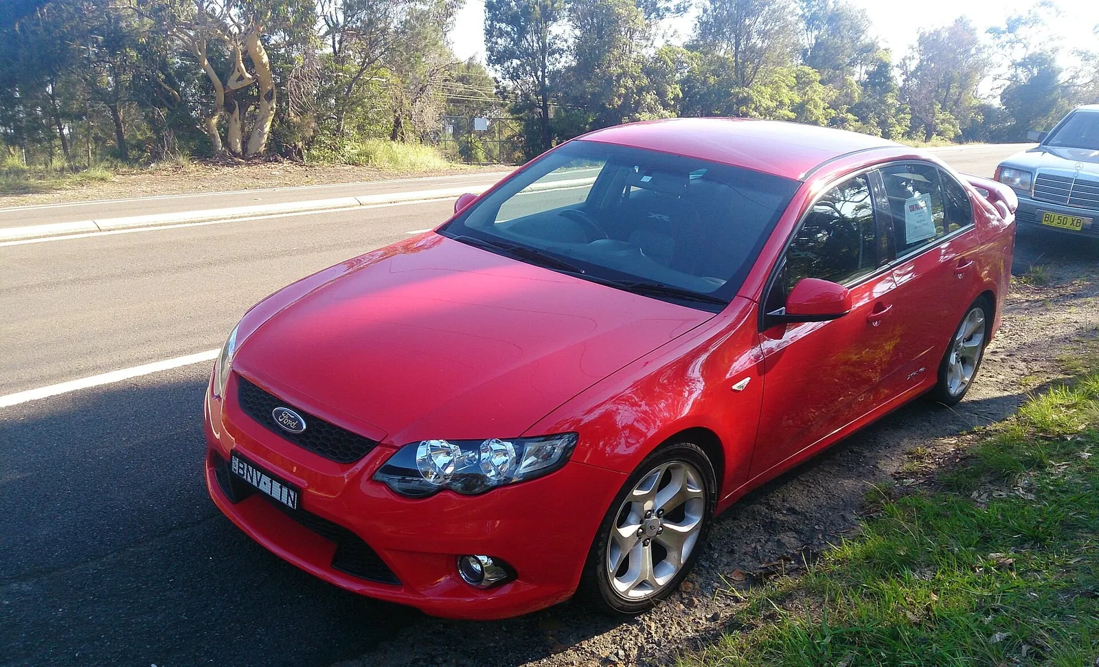 Red 2008 Ford FG Falcon XR6 Turbo sedan parked on a roadside verge, front three-quarter view