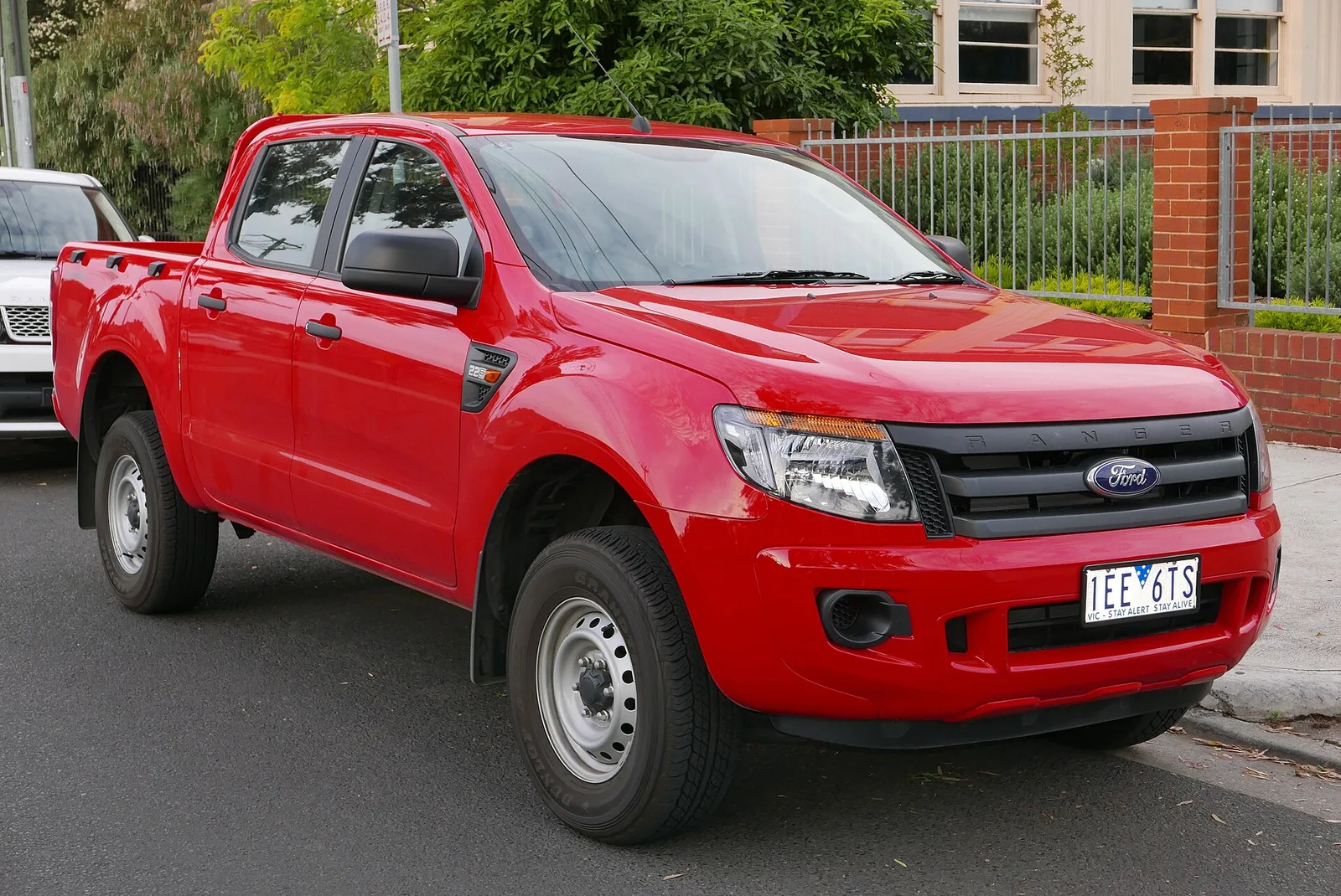 Red Ford Ranger XL dual-cab work ute on steel wheels parked on a street in Brunswick, Melbourne