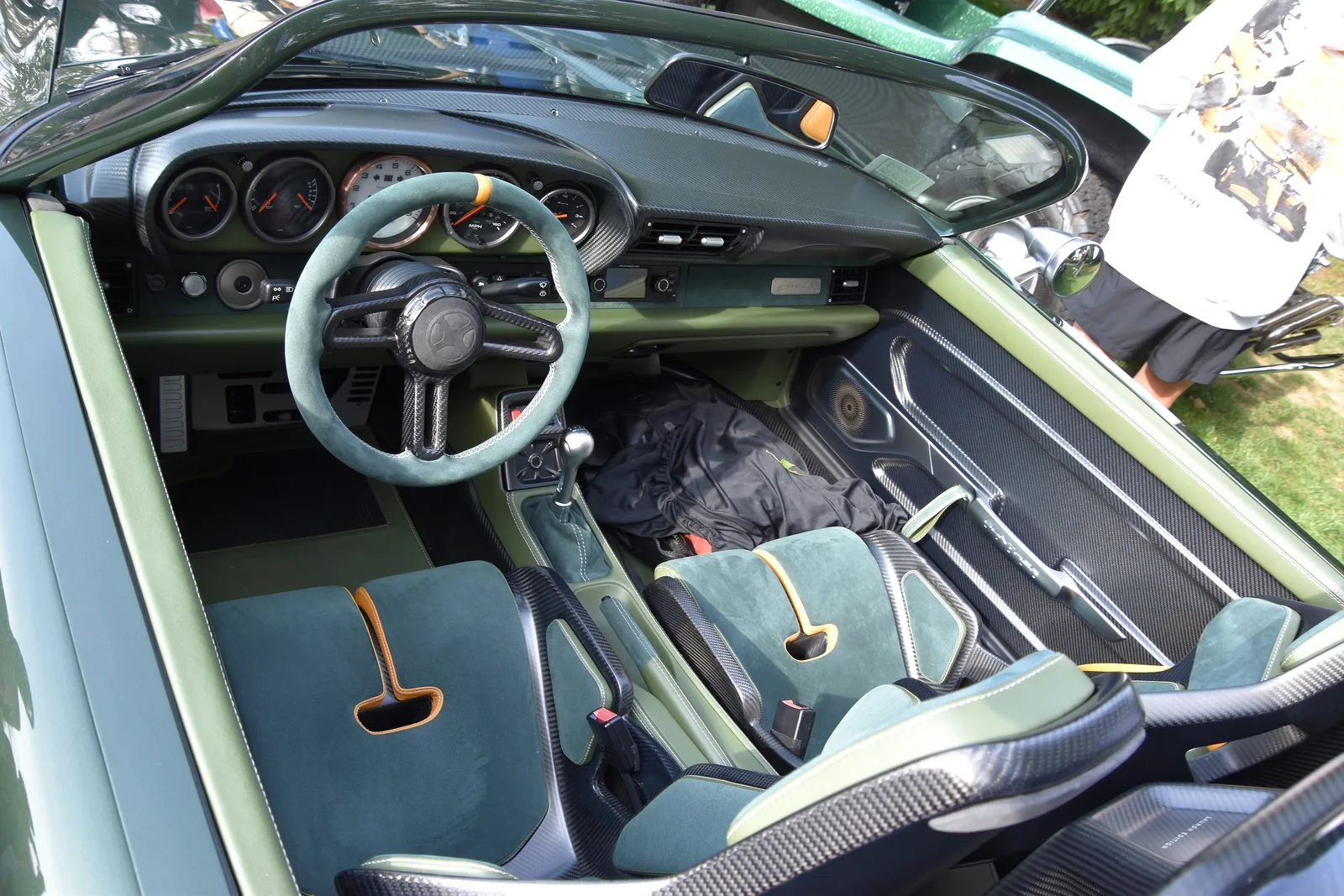Cabin of a Gunther Werks 993 Speedster with carbon-backed bucket seats, a five-dial cluster and green trim