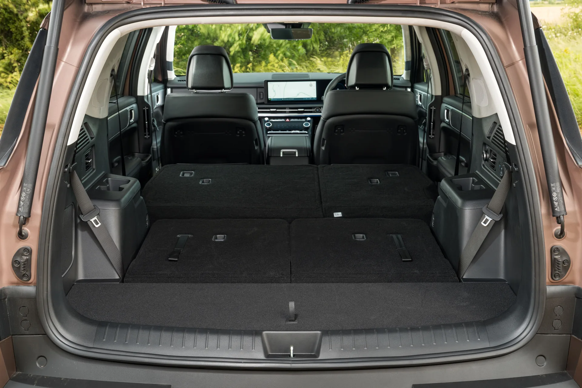 Hyundai Santa Fe boot viewed through the open tailgate with second and third rows folded flat