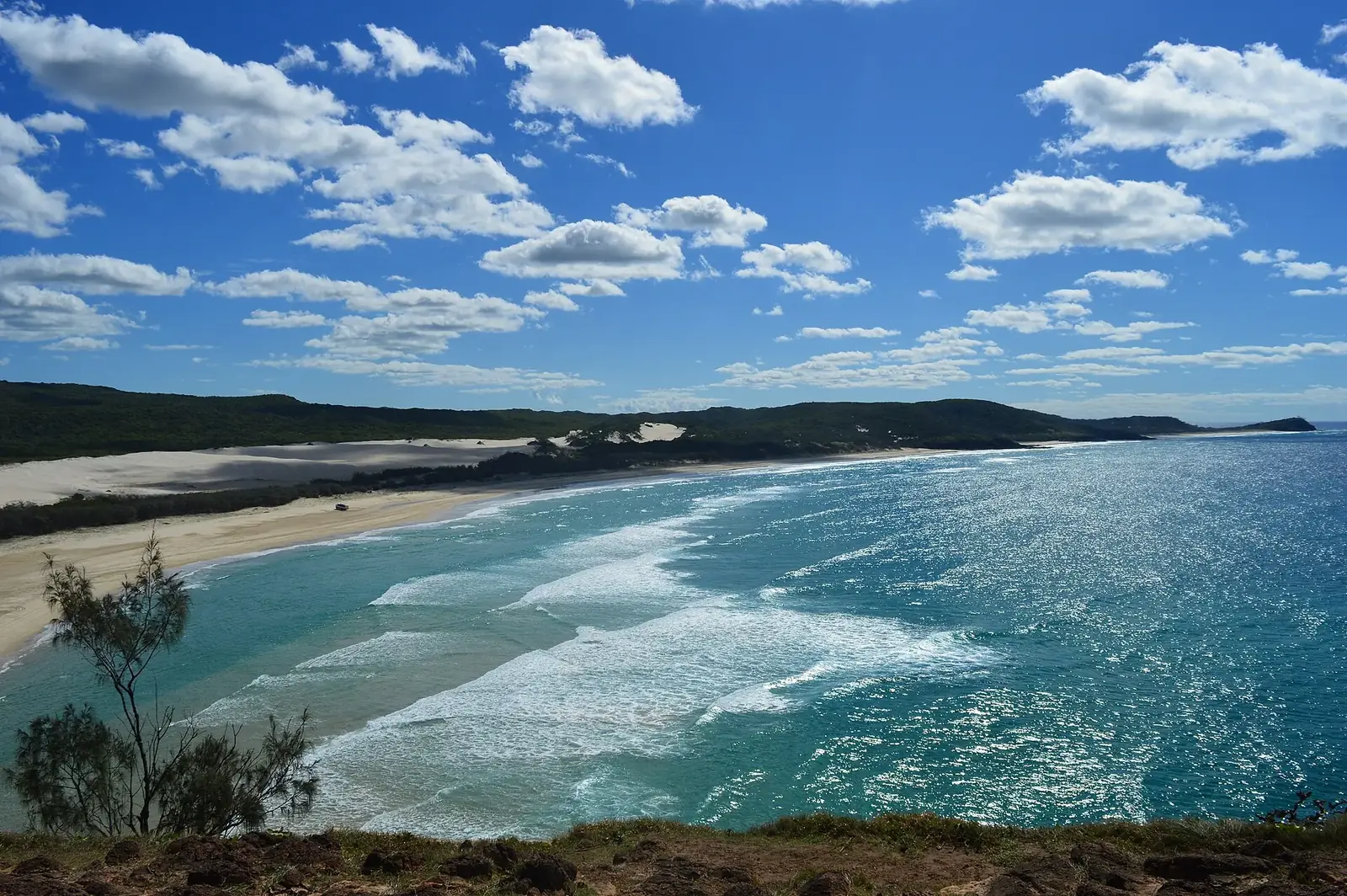 View south along the beach and surf of K'gari from the Tukkee Wurroo (Indian Head) headland