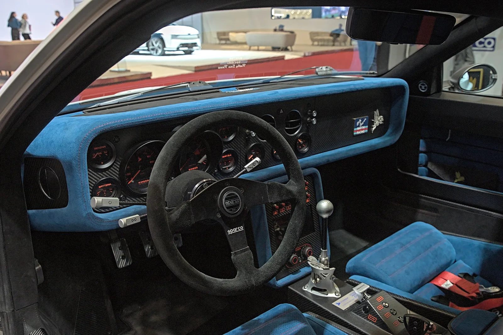Cabin of a Kimera EVO37 with blue Alcantara dash, Sparco steering wheel, analogue dials and exposed gear linkage