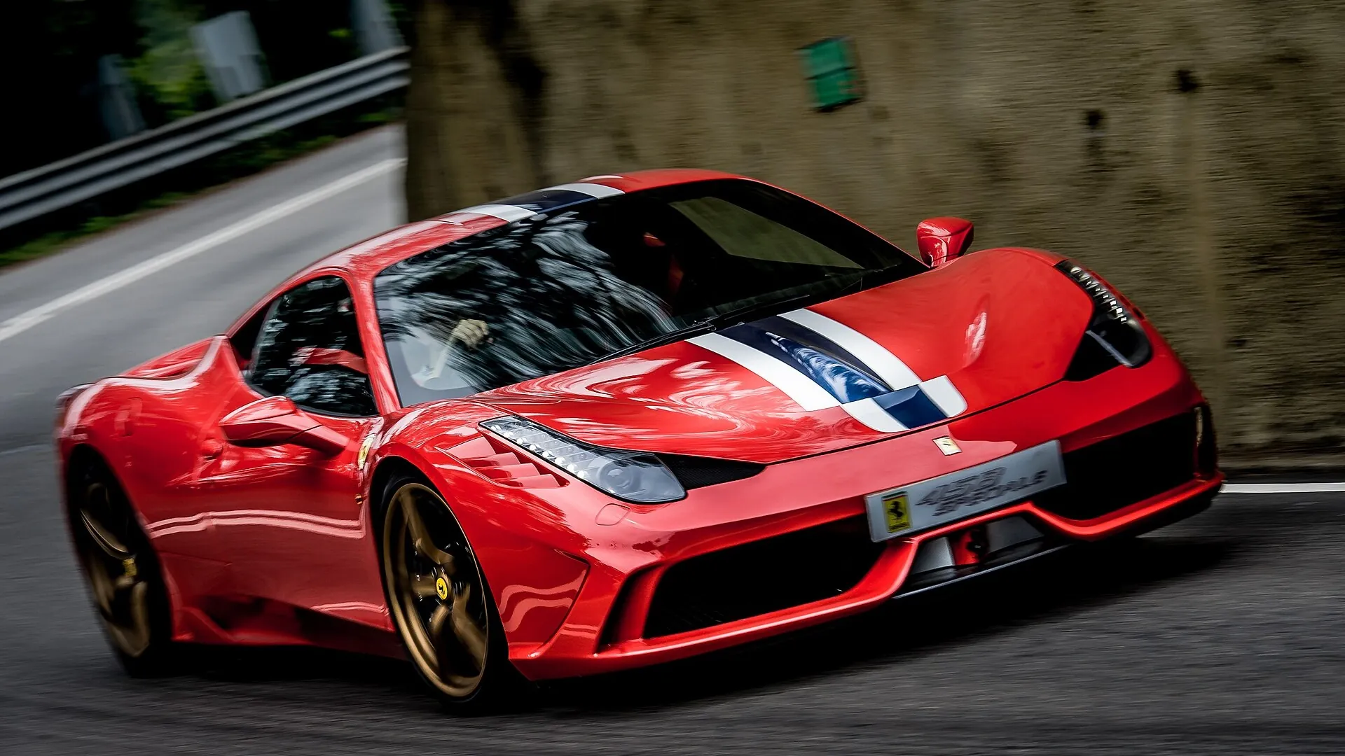 Ferrari 458 Speciale Red Ferrari 458 Speciale with blue and white NART-style stripes cornering on a mountain road, front three-quarter view