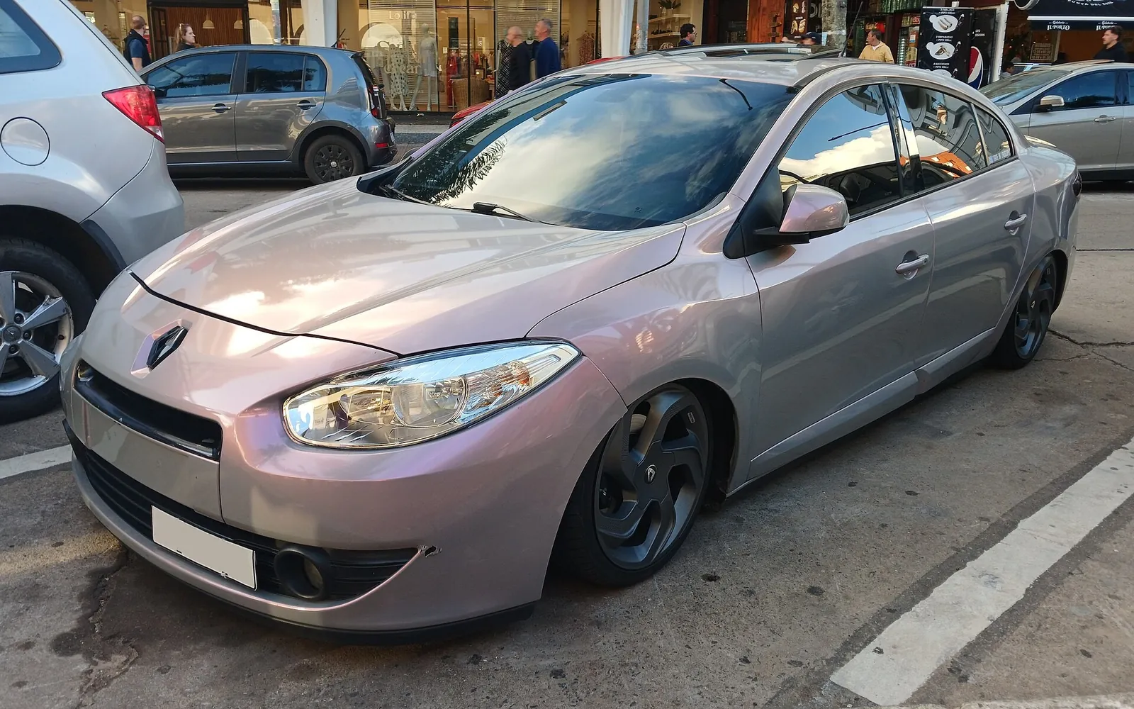 Lowered pearl Renault Fluence sedan parked at a kerb, showing a low front lip and tucked wheel arches
