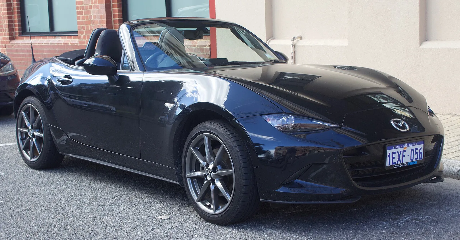Dark blue Mazda MX-5 ND Roadster GT parked in Fremantle, Western Australia, roof folded