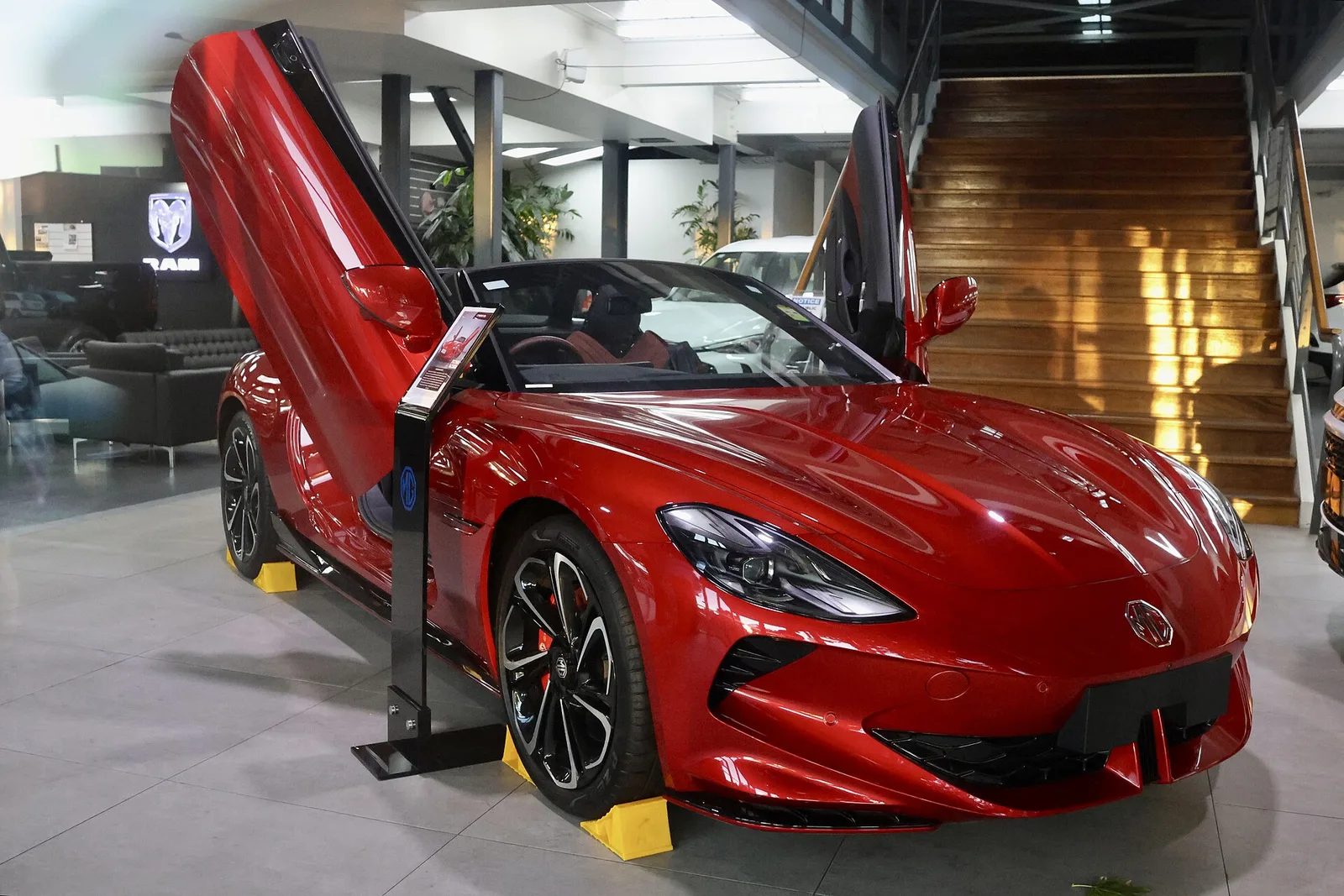 Red MG Cyberster with both electric scissor doors raised on display at an Adelaide dealership