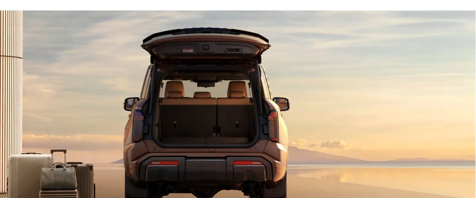 Rear of the 2027 Mitsubishi Pajero with the tailgate open showing the boot with the third row raised