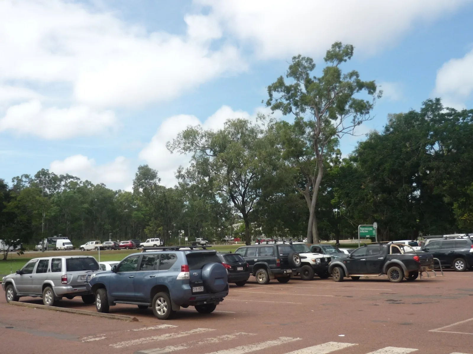 4WDs and utes parked in full sun in an open car park in Weipa, far north Queensland