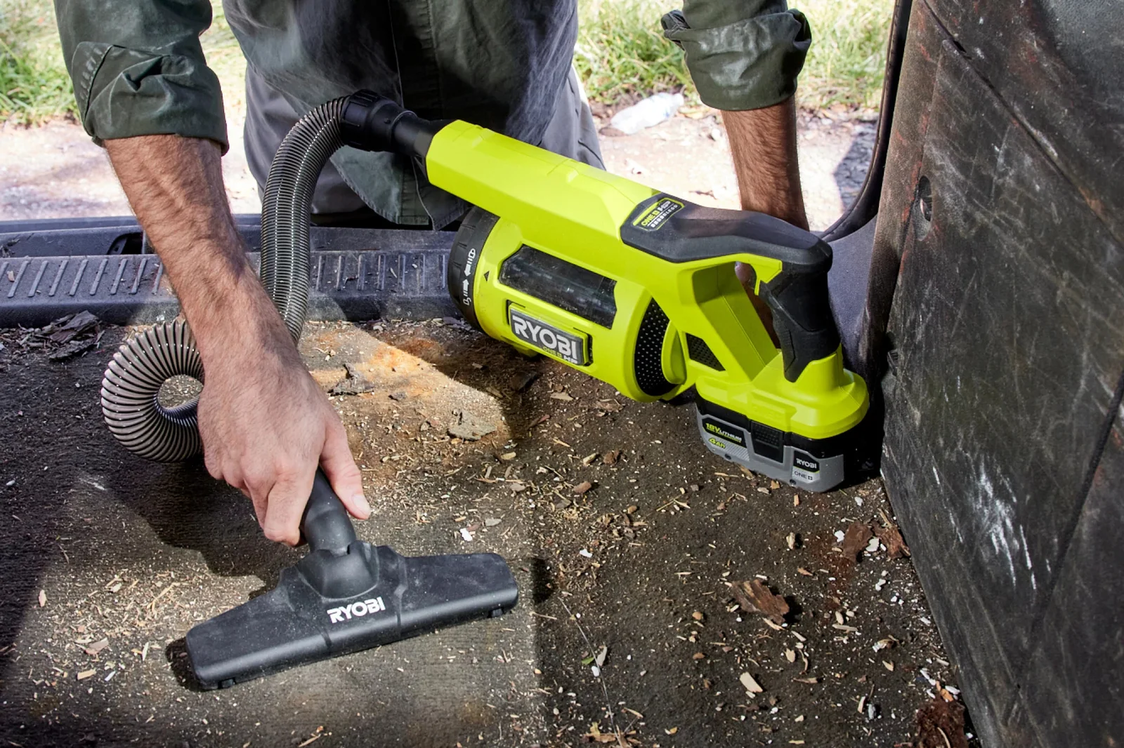 Ryobi 18V ONE+ HP brushless hand vacuum with flexi hose and floor nozzle clearing dirt and wood chips