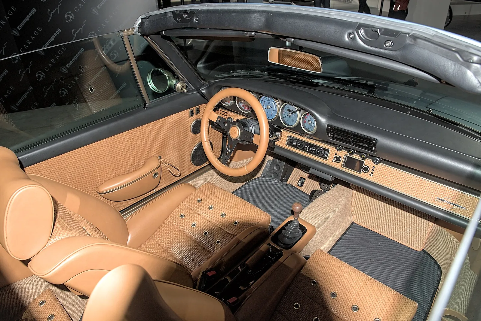 Tan leather and basket-weave interior of a Singer 911 Classic Targa, seen from above with the roof removed