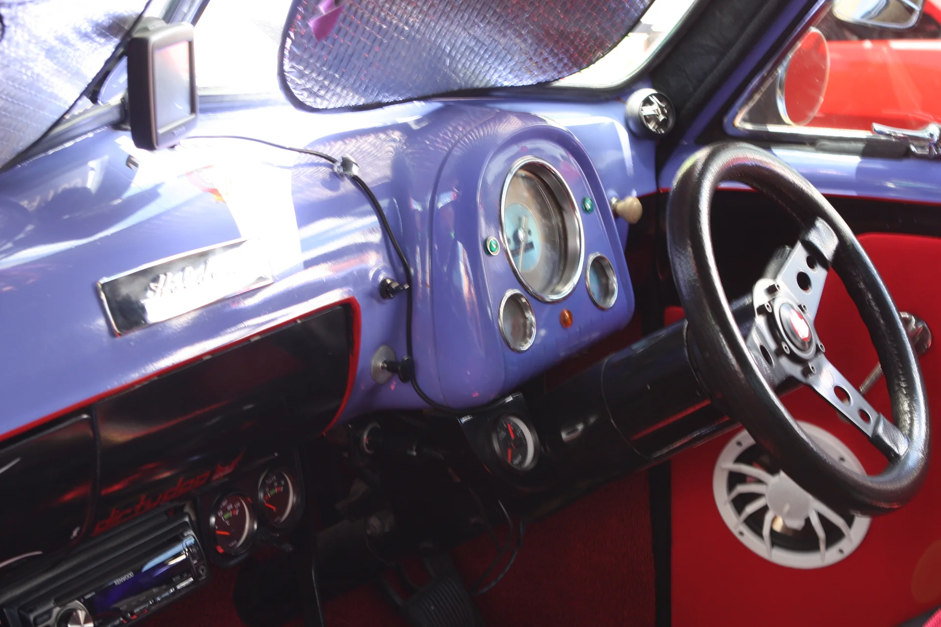 Custom purple dash, billet steering wheel and red trim inside a modified 1956 Holden FJ ute at Summernats