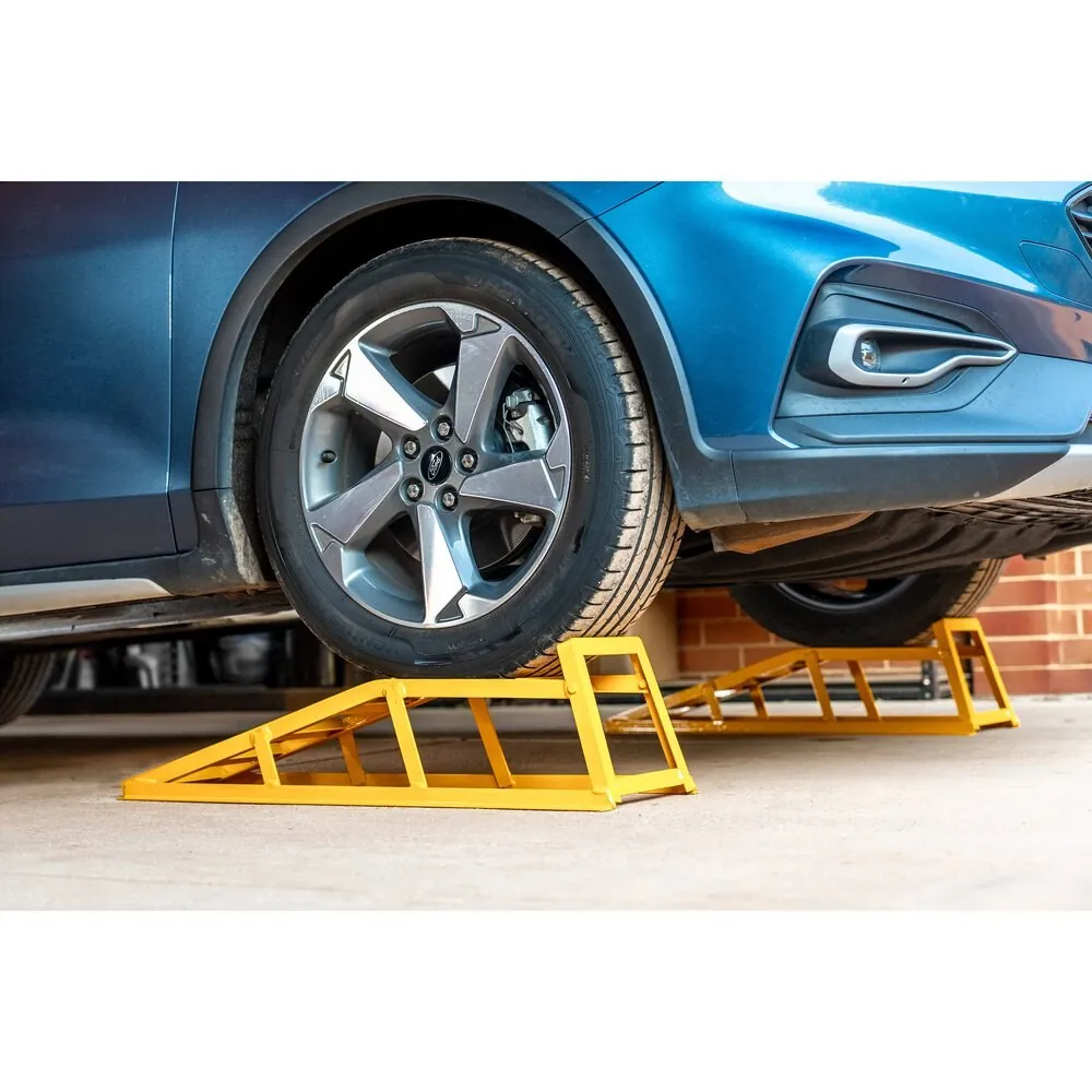 Yellow ToolPRO 850kg steel car ramps under the front wheel of a blue SUV
