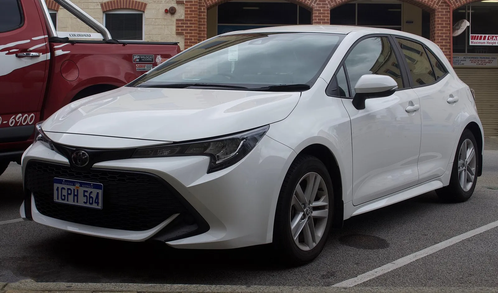 White 2018 Toyota Corolla Ascent Sport hatchback, the E210 generation (MZEA12R), front three-quarter view