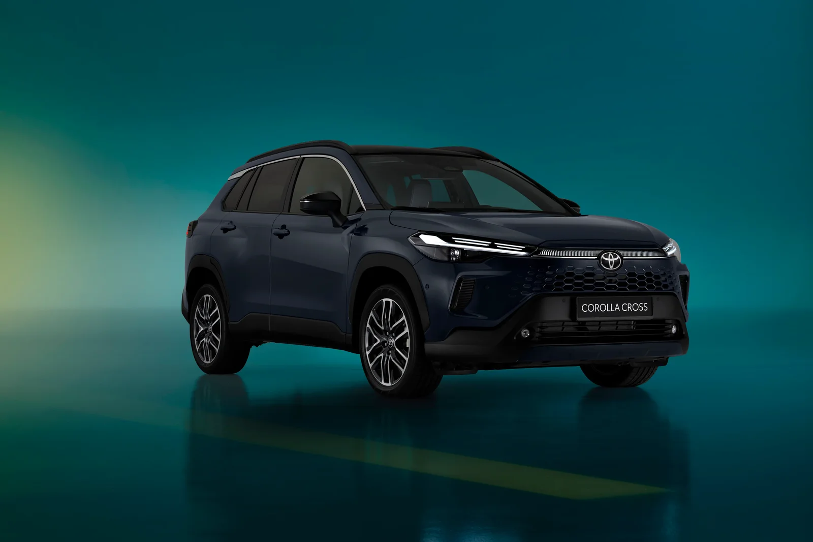2025 Toyota Corolla Cross Hybrid small SUV in dark grey, front three-quarter studio view