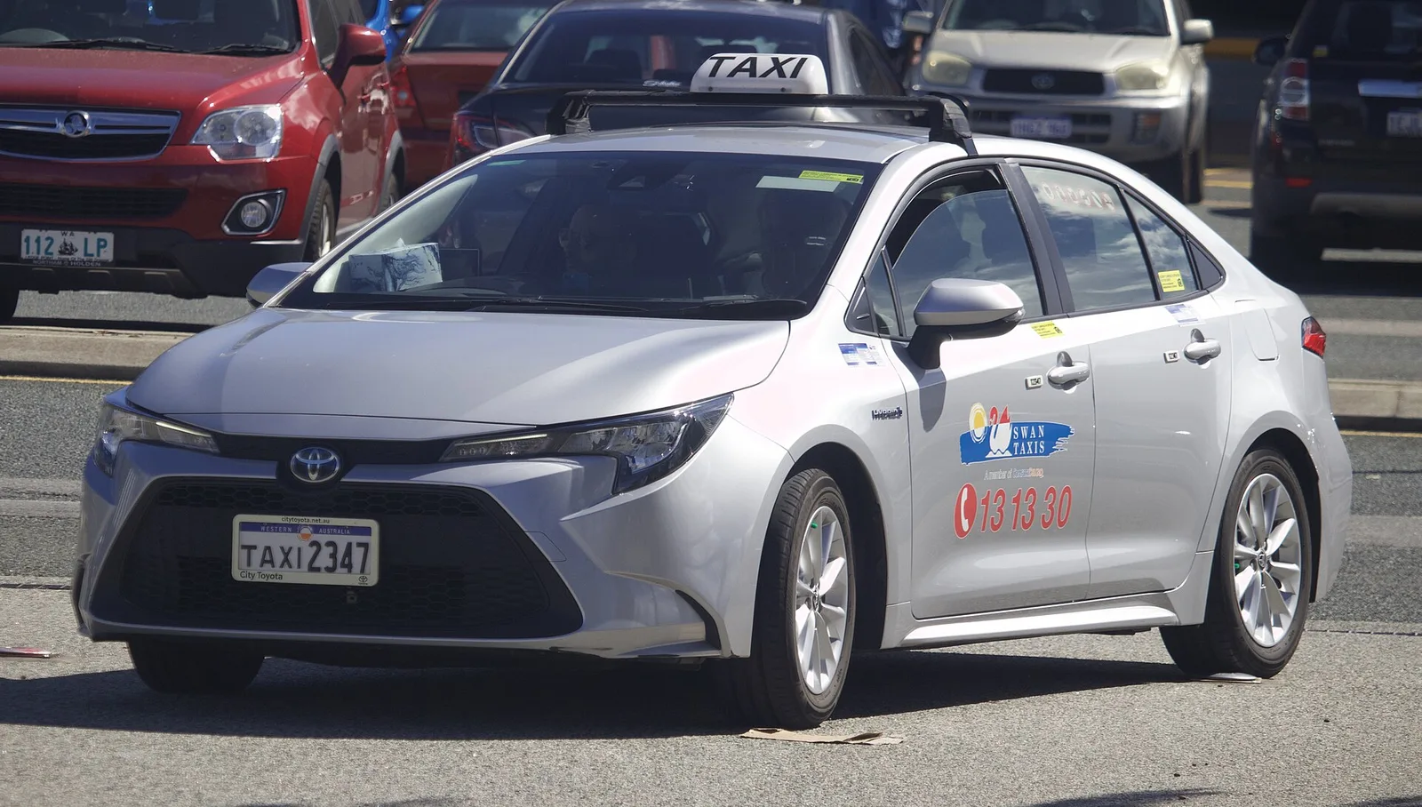 Silver Toyota Corolla Hybrid sedan working as a taxi on a street in Fremantle, Western Australia