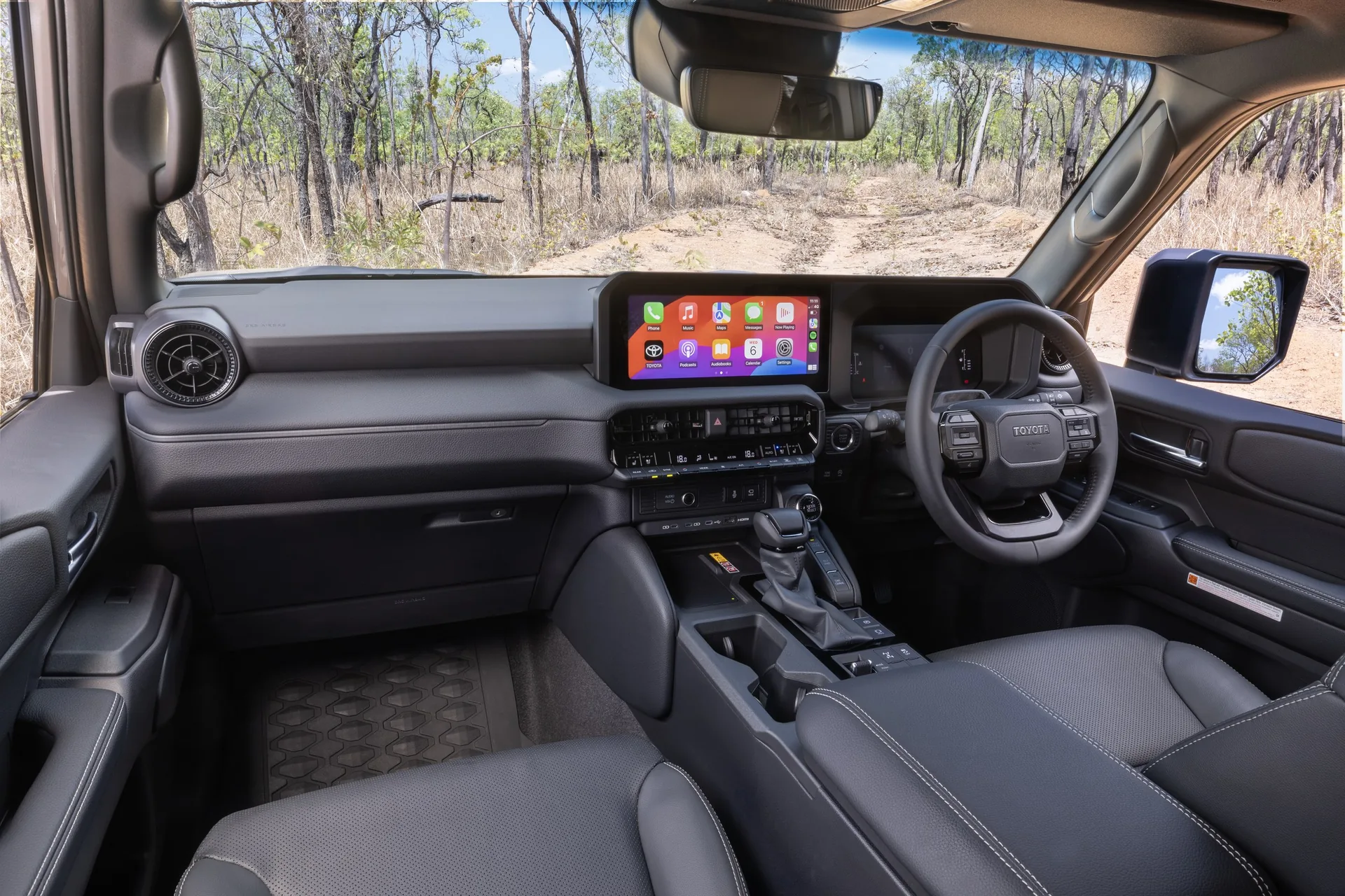 Toyota LandCruiser Prado GXL dashboard with a 12.3-inch touchscreen, physical climate controls and gear selector