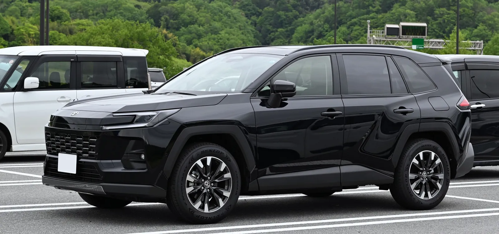 Black sixth-generation Toyota RAV4 Hybrid in a car park, a Japanese-market car with the same face as Australian grades