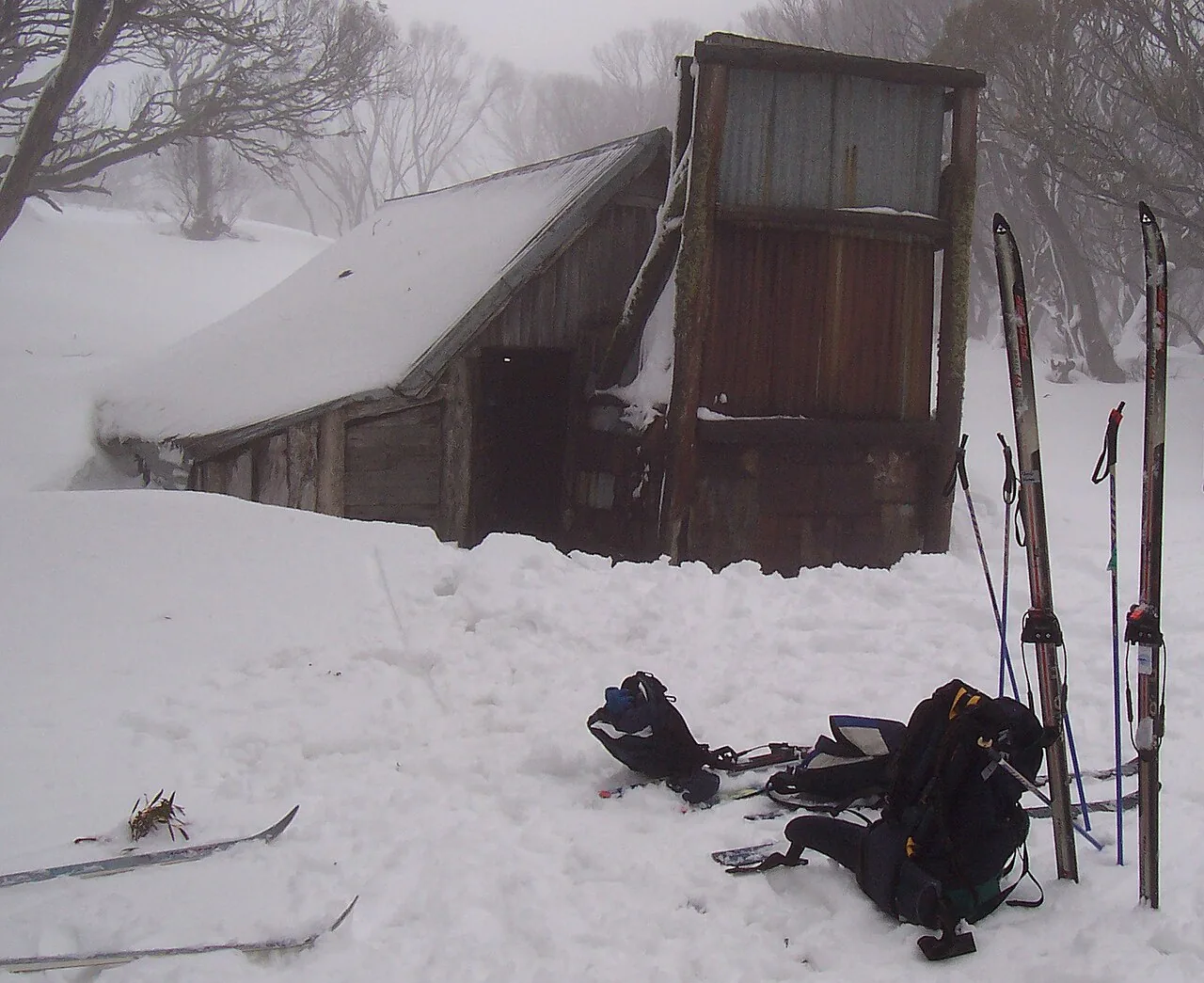 Wallace Hut, the cattlemen's hut built in 1889 on the Bogong High Plains, under snow with skis outside