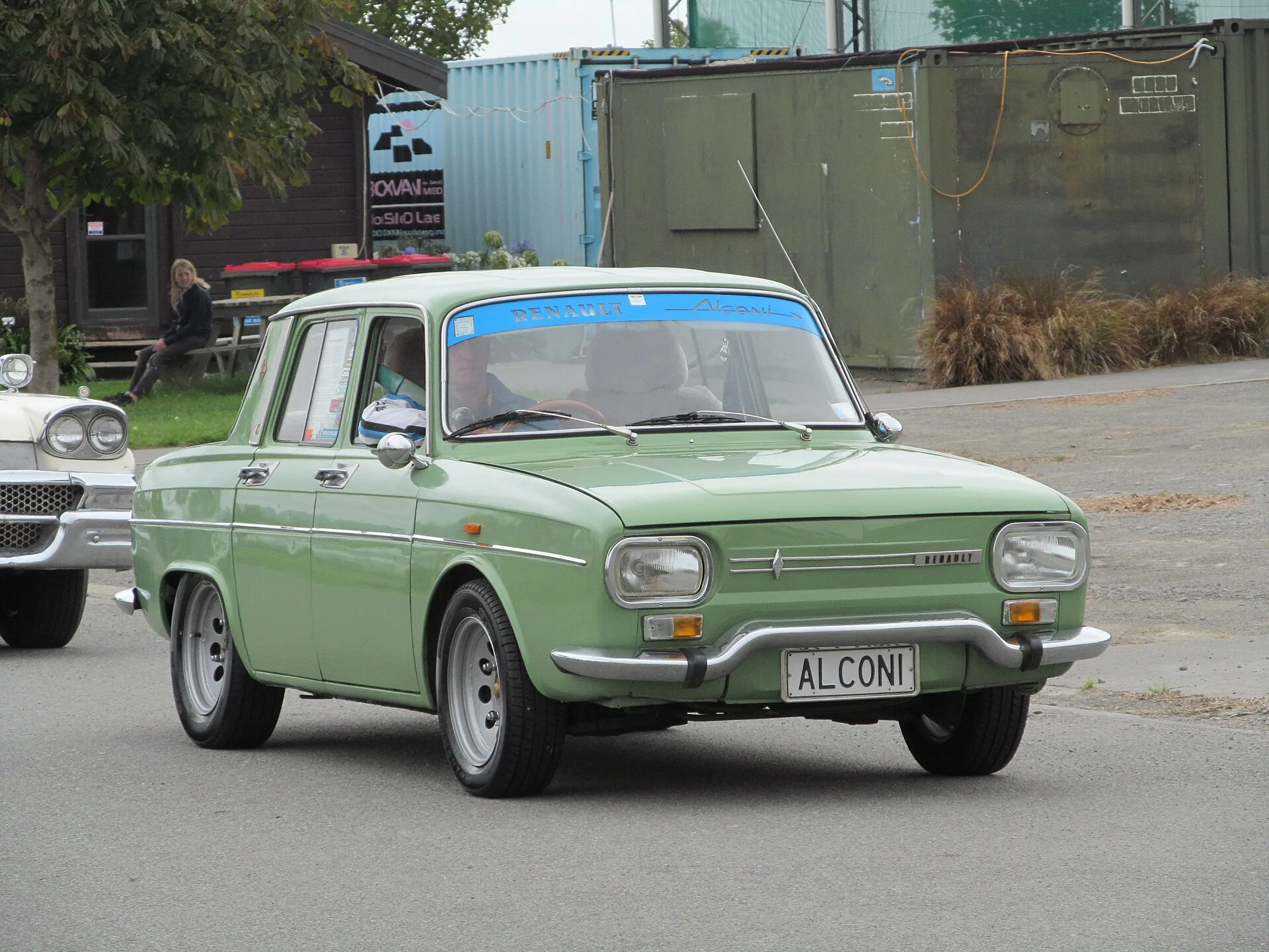 Green 1970 Renault 10 with a tinted sun strip band across the top of its windscreen, photographed in New Zealand