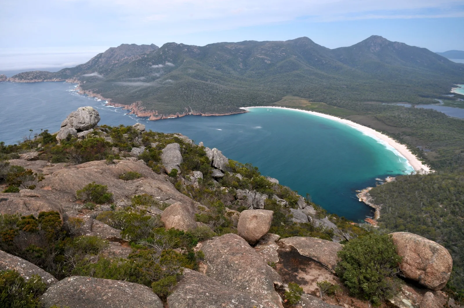 Wineglass Bay's curved white beach and The Hazards seen from the summit of Mount Amos in Freycinet National Park